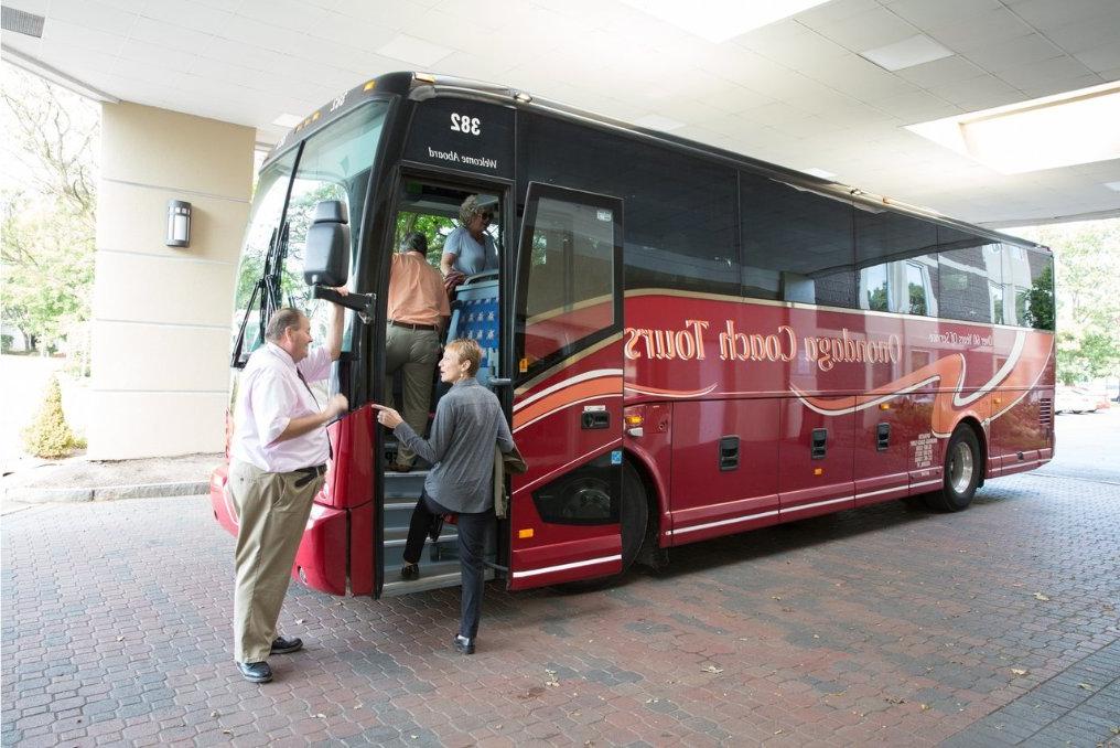 Visitors board a Onondaga Coach Tours bus.